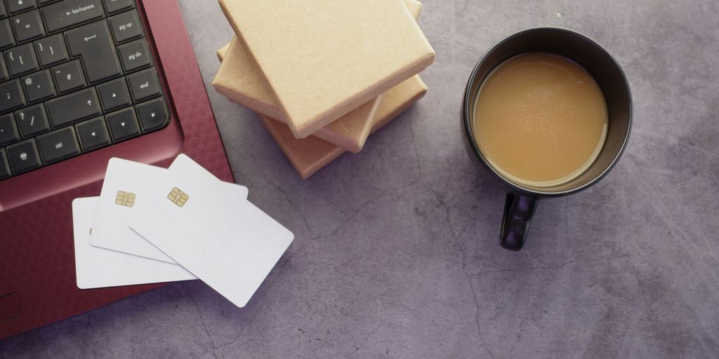 a cup of coffee sitting next to a laptop computer
